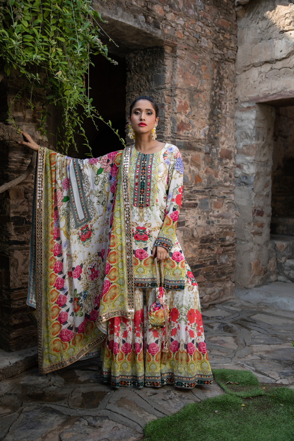 IVORY FLORAL PRINTED SHORT KURTI WITH KALIDAR SHARARA AND POTLI BAG