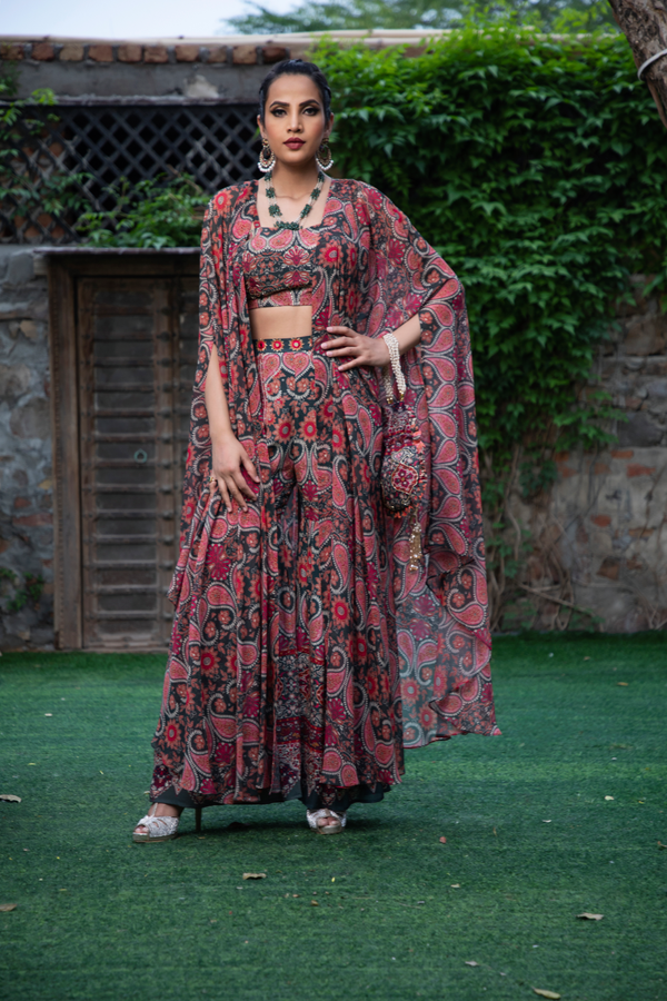 RED & GREEN PRINTED LONG SHRUG WITH BUSTIER, FLARE PANT AND POTLI BAG