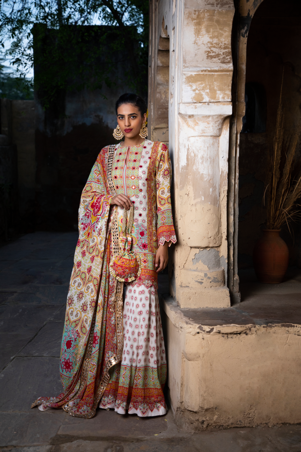 IVORY & RED PRINTED SHORT KURTA WITH KALIDAR SHARARA AND POTLI BAG