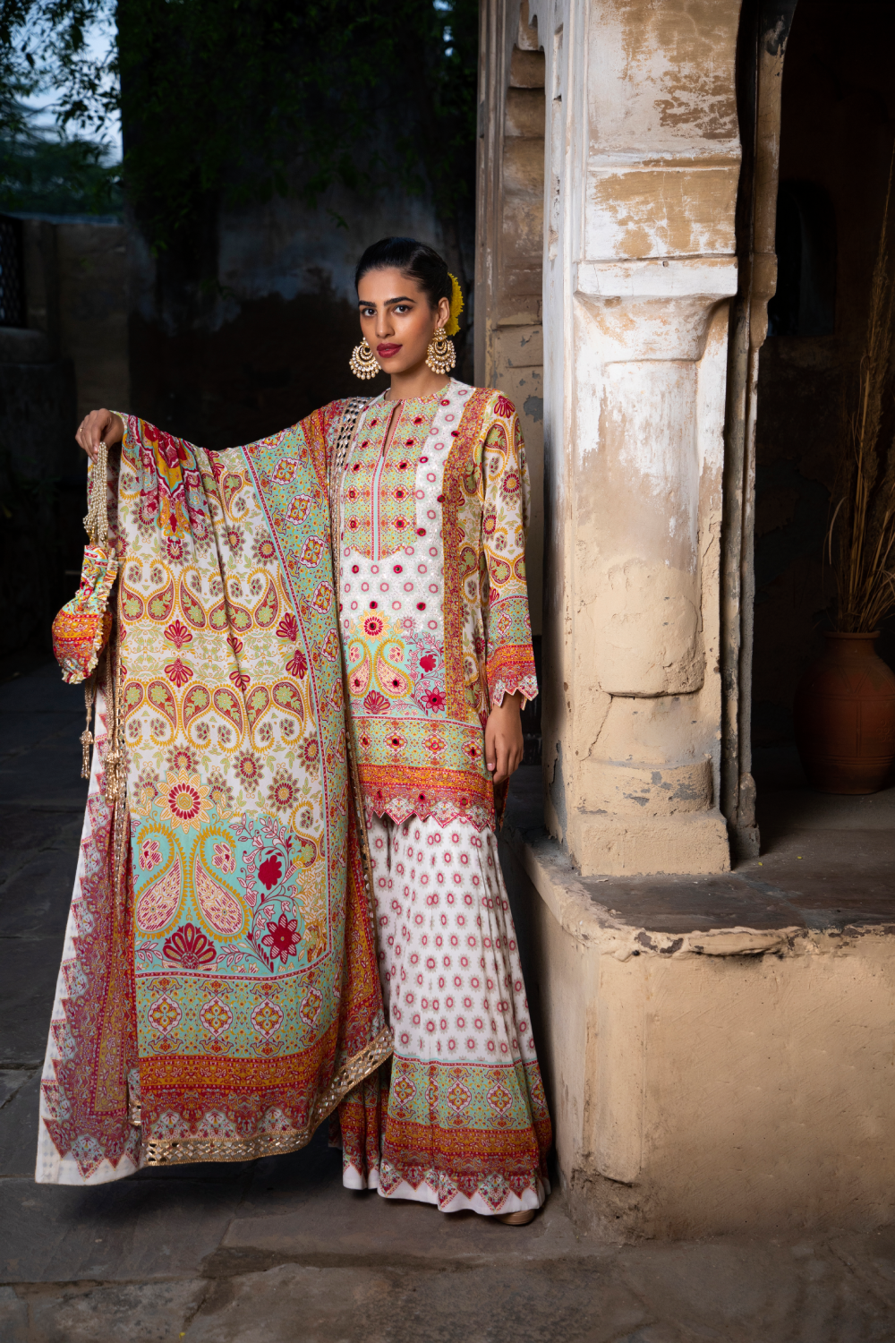 IVORY & RED PRINTED SHORT KURTA WITH KALIDAR SHARARA AND POTLI BAG