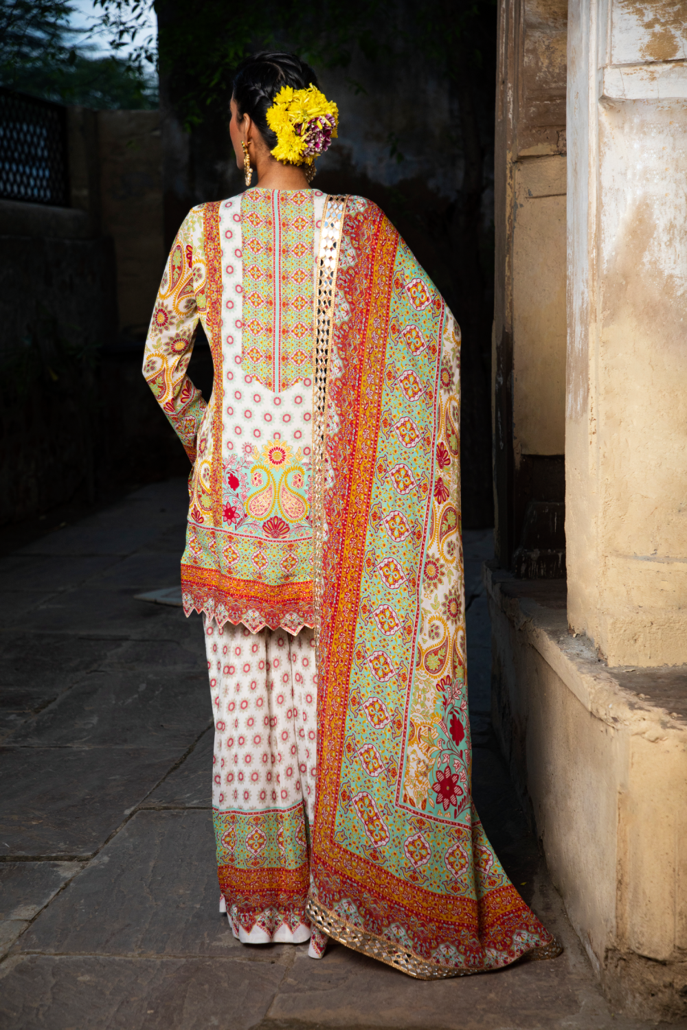 IVORY & RED PRINTED SHORT KURTA WITH KALIDAR SHARARA AND POTLI BAG