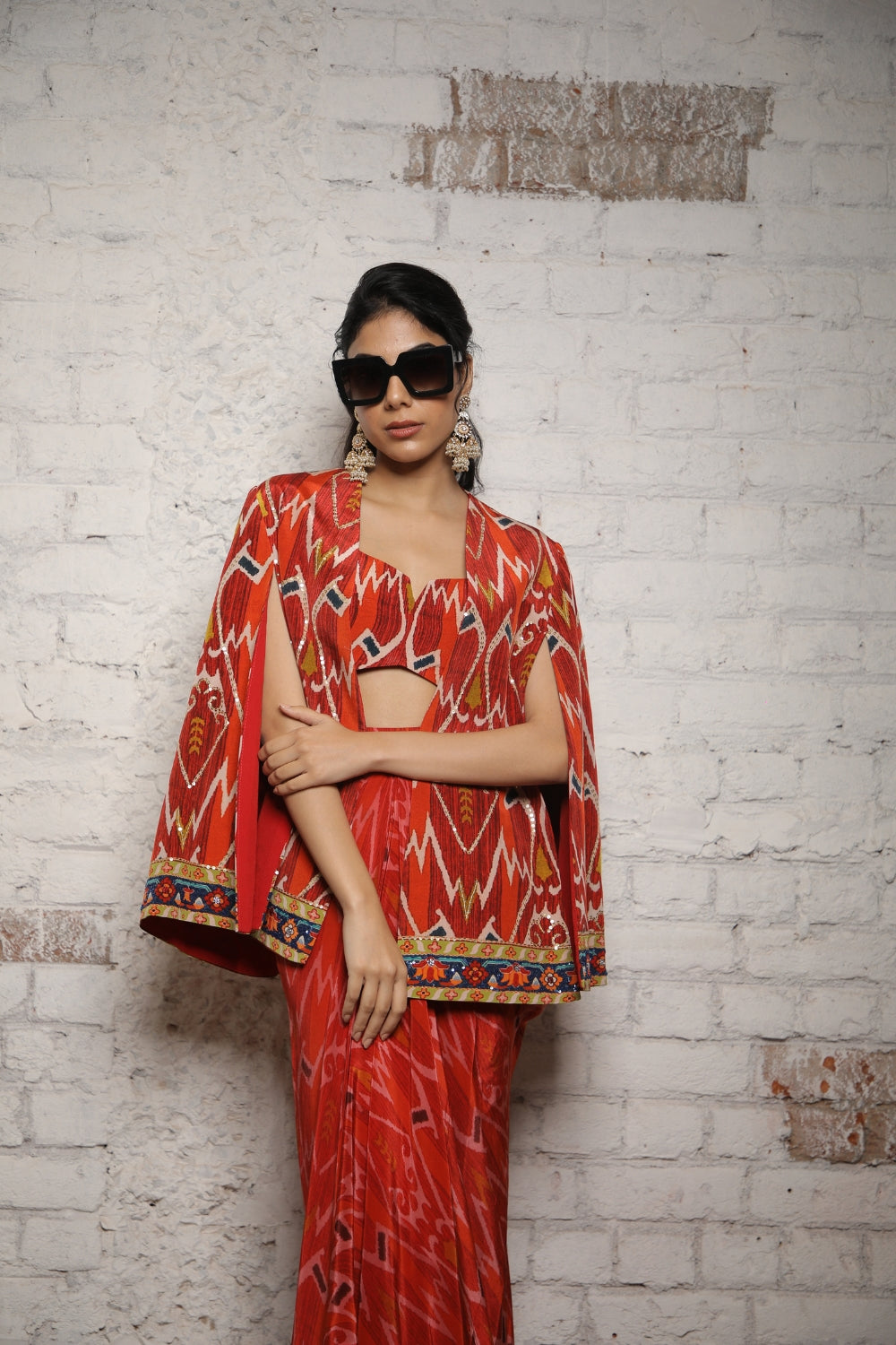 RED IKKAT PRINTED CAPE WITH BUSTIER AND SELF PRINTED SKIRT