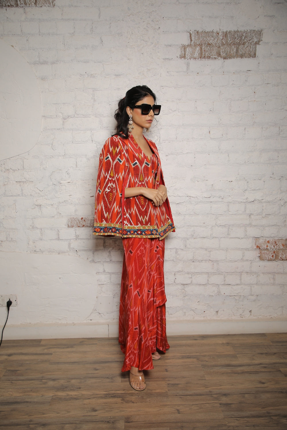 RED IKKAT PRINTED CAPE WITH BUSTIER AND SELF PRINTED SKIRT